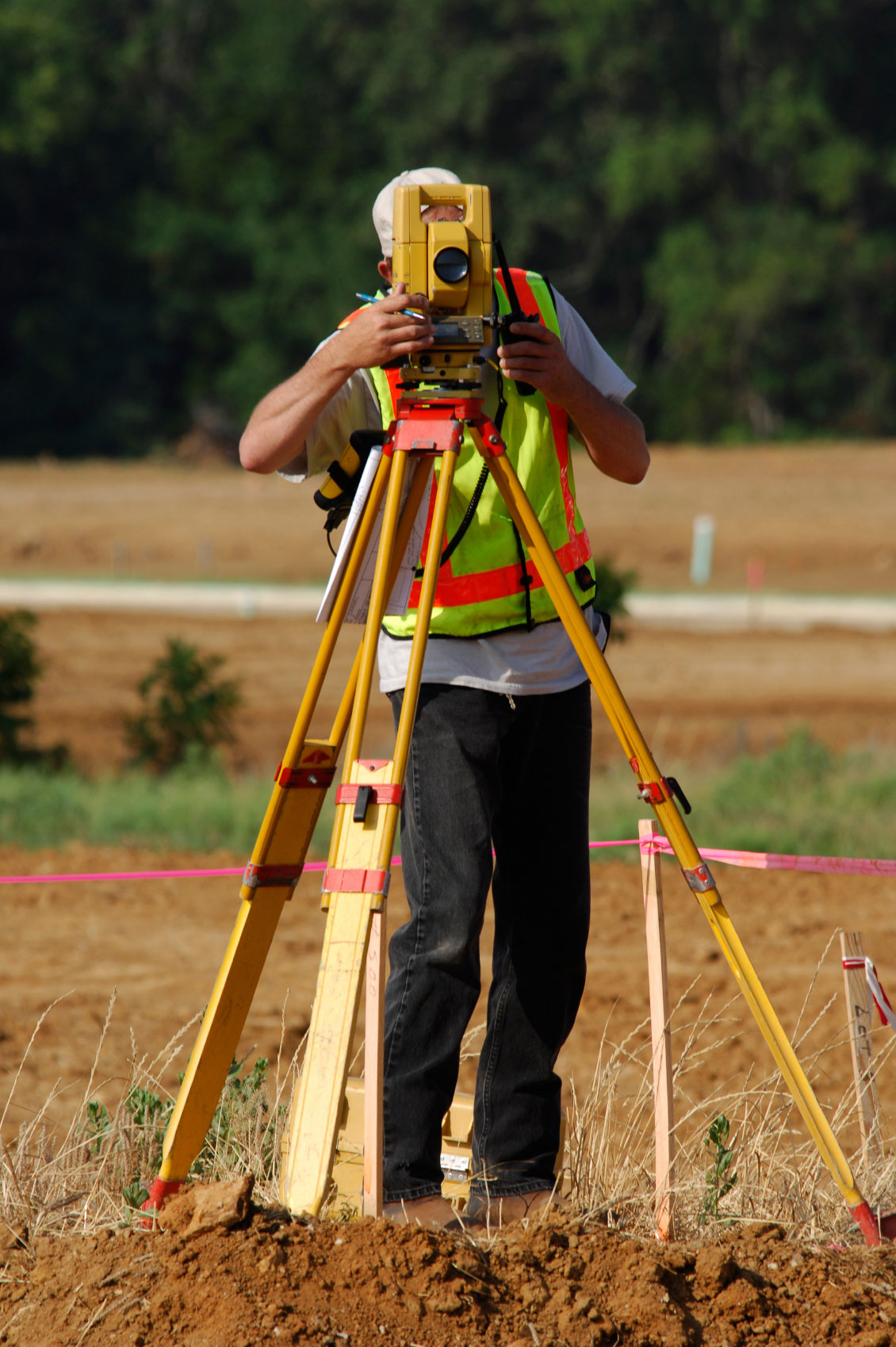 Surveyor sighting through total station